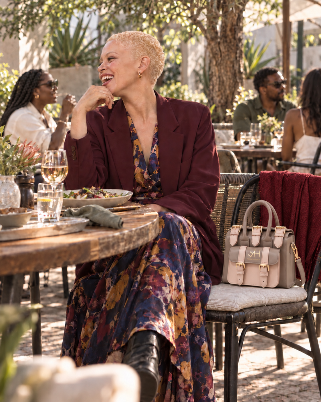 Woman dining beside a Frank Harvey Safety Handbag with red cloth backdrop